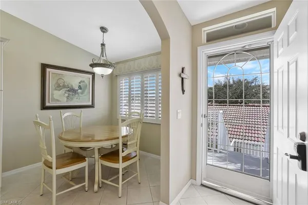 a dining room with furniture large window and glass door