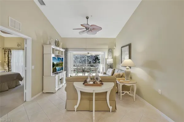 a dining room with furniture a chandelier and window