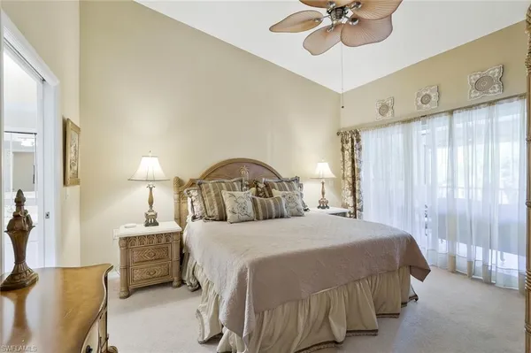 a bedroom with a bed couch and window