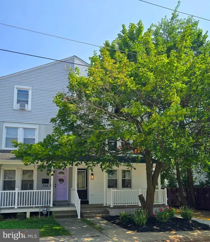 front view of a house with a tree