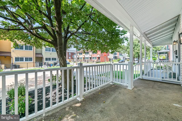 a view of a house with a large window and wooden fence