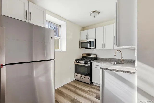 a kitchen with a refrigerator sink and stove