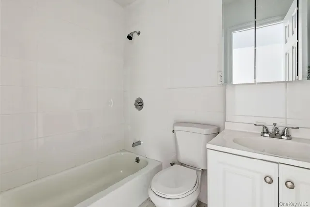 a bathroom with a sink a toilet and bathtub