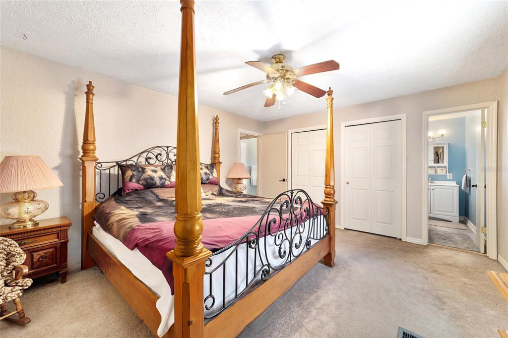 15755 Southwest 90th Avenue Dunnellon, FL 34432 - Photo 30 of 55 a bed room with a bed and a chandelier