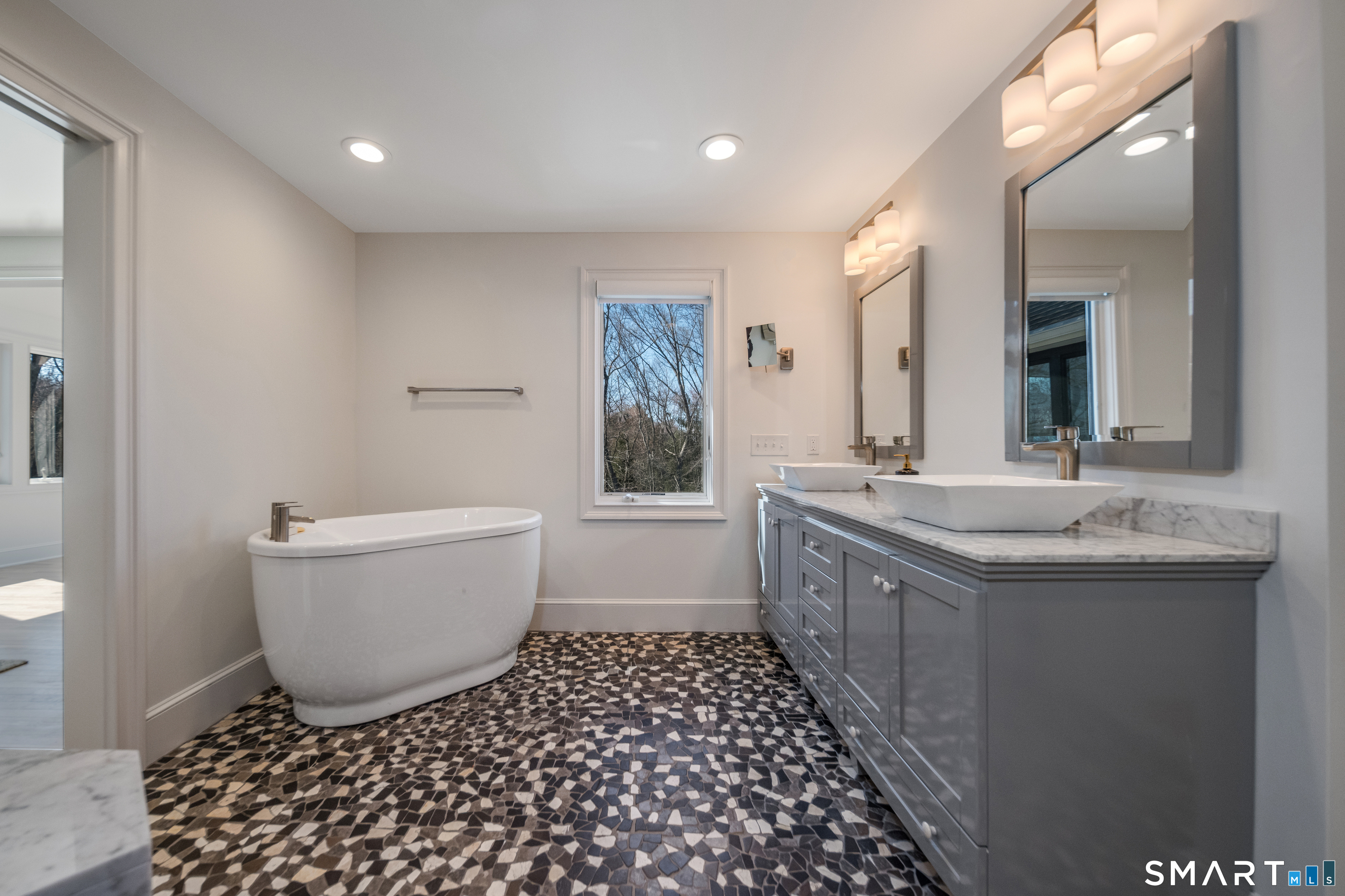 45 Island Avenue Madison, CT 06443 - Photo 19 of 38 a bathroom with a granite countertop sink and a bathtub