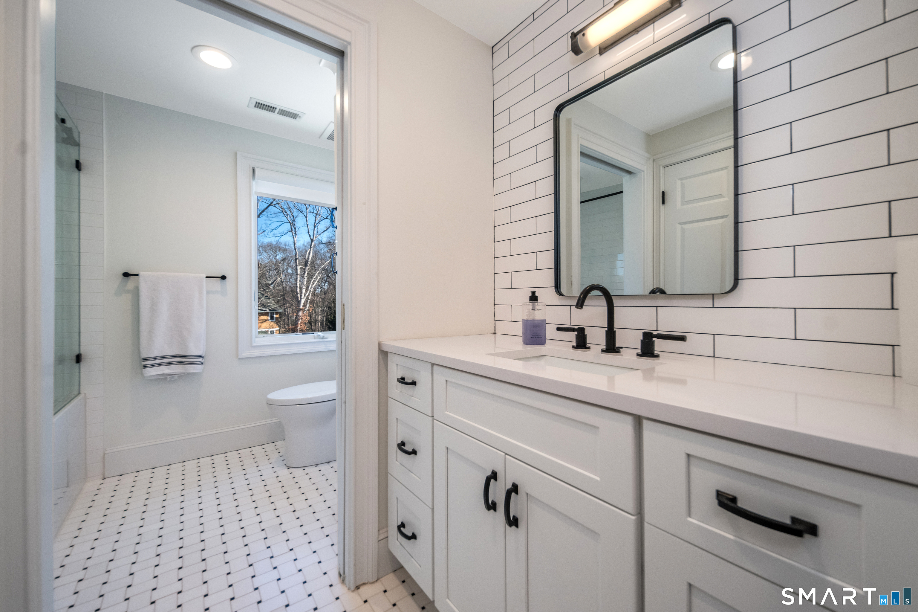 45 Island Avenue Madison, CT 06443 - Photo 21 of 38 a bathroom with a sink a toilet and a mirror