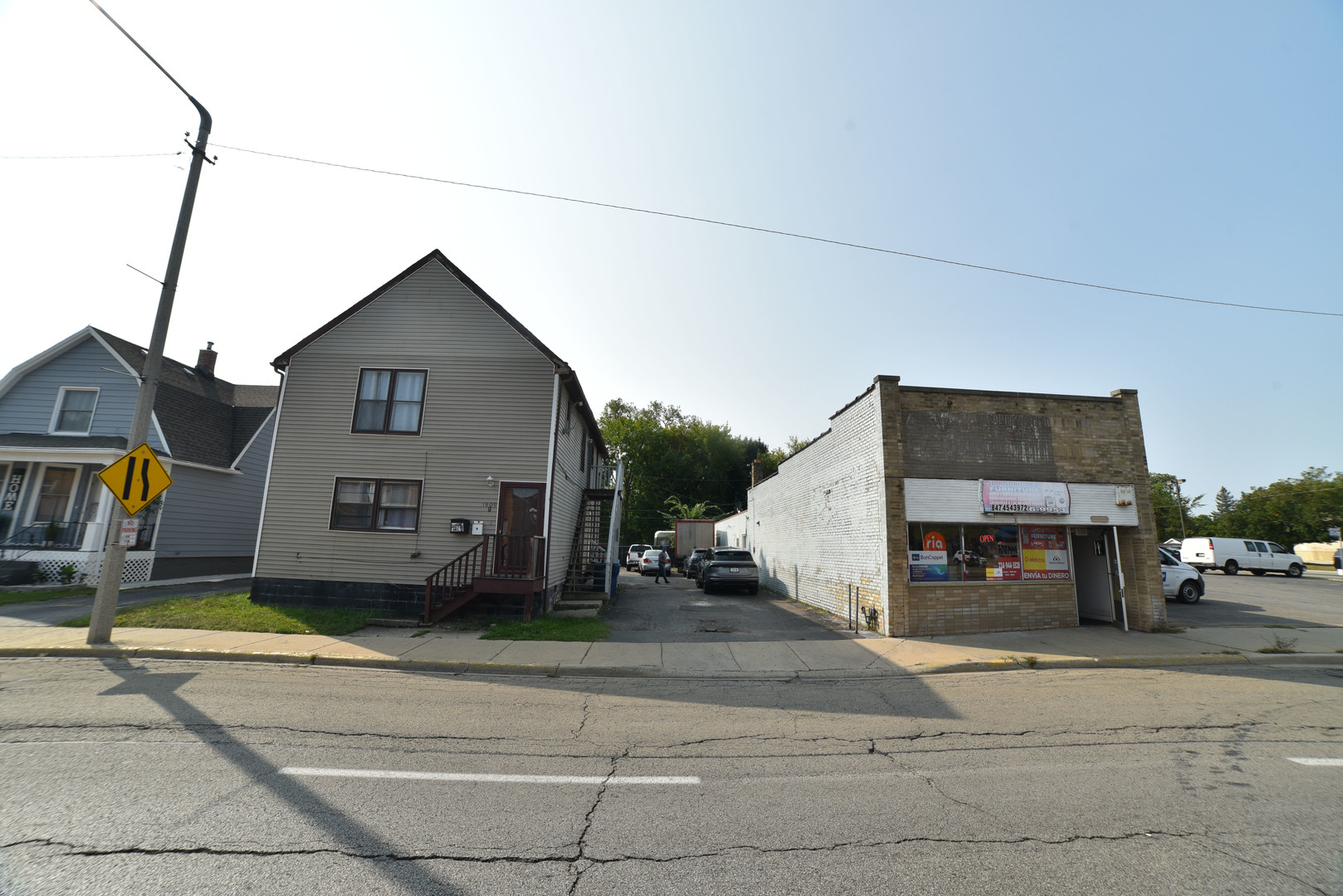 1809 Washington Street Waukegan, IL 60085 - Photo 1 of 16 a front view of a house with a yard and garage