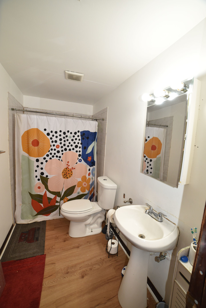 1809 Washington Street Waukegan, IL 60085 - Photo 11 of 16 a bathroom with a toilet sink and mirror