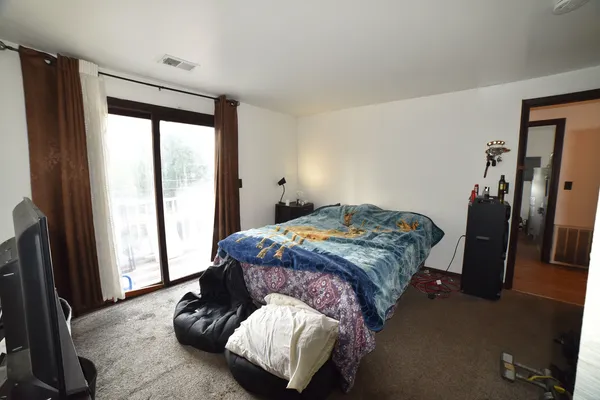 a bedroom with a bed and a window