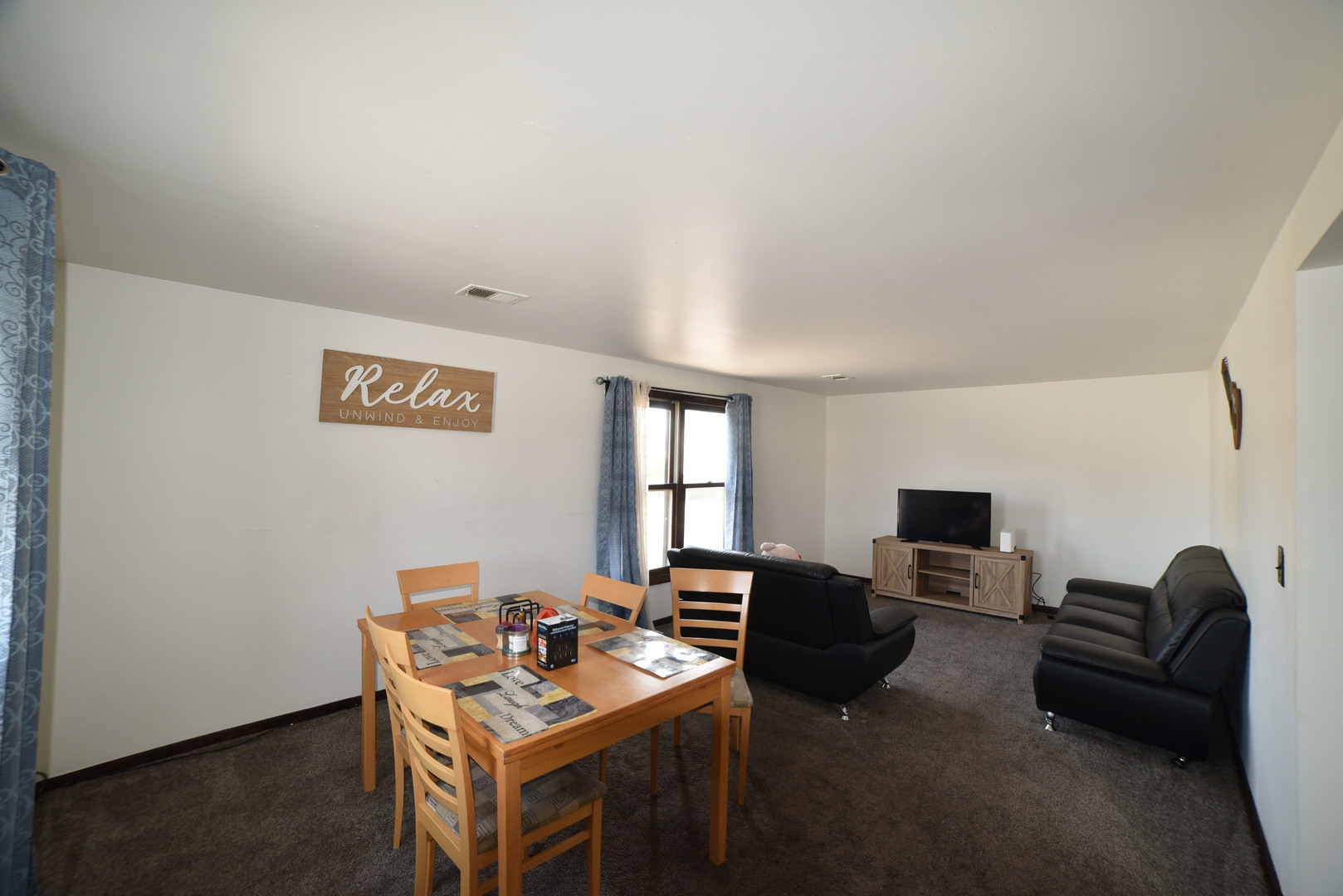 1809 Washington Street Waukegan, IL 60085 - Photo 8 of 16 a work room with furniture a flat screen tv and a window