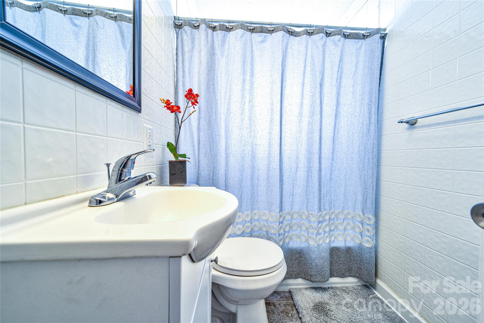 308 South Myrtle School Road Gastonia, NC 28052 - Photo 17 of 22 a bathroom with a sink a toilet and shower curtain