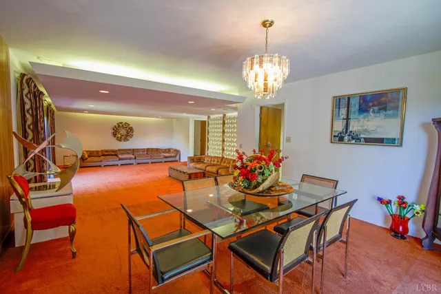 a view of a livingroom with furniture and kitchen view