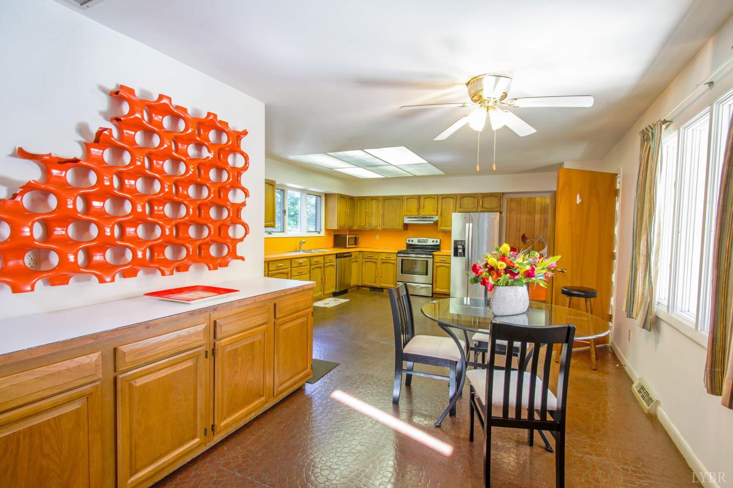 151 Clarks Road Rustburg, VA 24588 - Photo 16 of 81 a dining hall with stainless steel appliances granite countertop a dining table and chairs with wooden floor