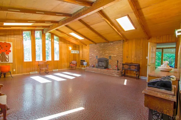 a living room with furniture a rug and a large window