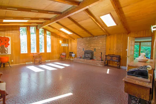 a living room with furniture a rug and a large window