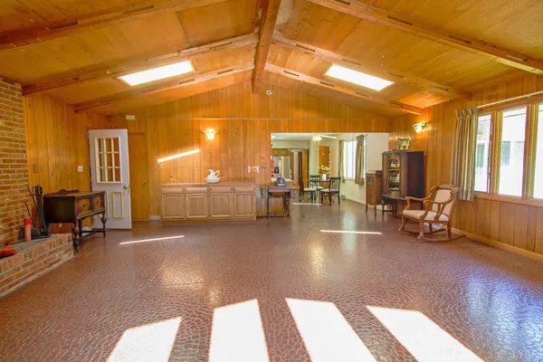 a spacious bedroom with a bed and a window