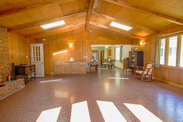 a spacious bedroom with a bed and a window