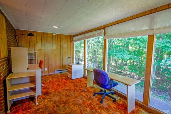 a bed sitting in a bedroom next to a window