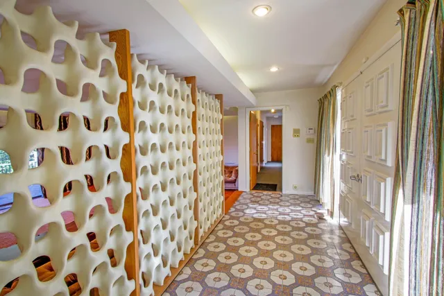 a view of an empty room with a fireplace and a window