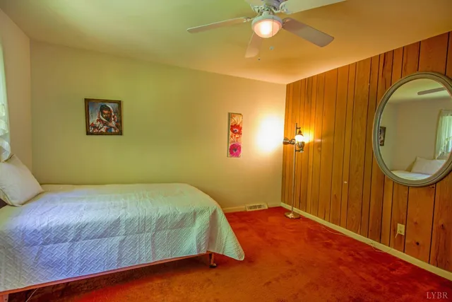 a bedroom with a bed and a television