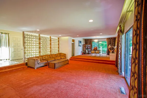 a dining room with furniture and chandelier kitchen view