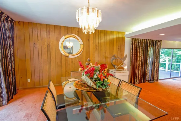 a dining hall with stainless steel appliances granite countertop a dining table and chairs with wooden floor