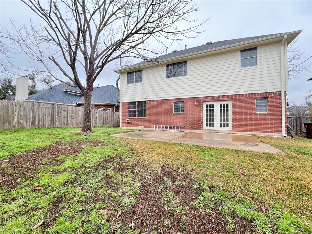 1809 Springwater Drive Round Rock, TX 78681 - Photo 18 of 25 Rear view of house featuring a fenced backyard, brick siding, a patio, and french doors