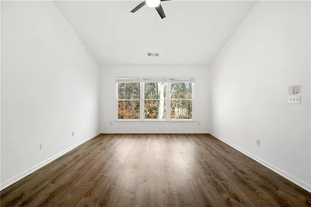a bathroom with a granite countertop sink a toilet and a shower