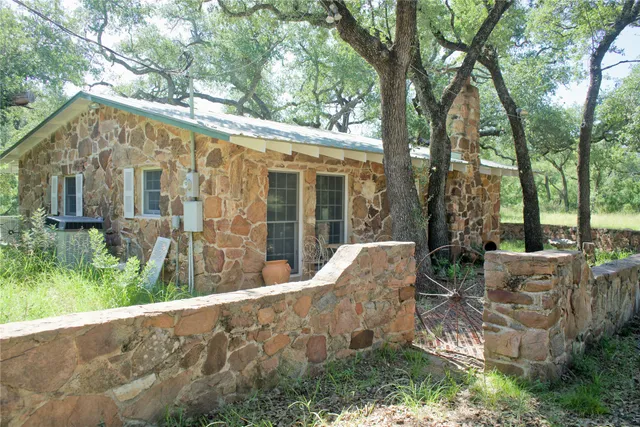 a view of a chair and table in backyard