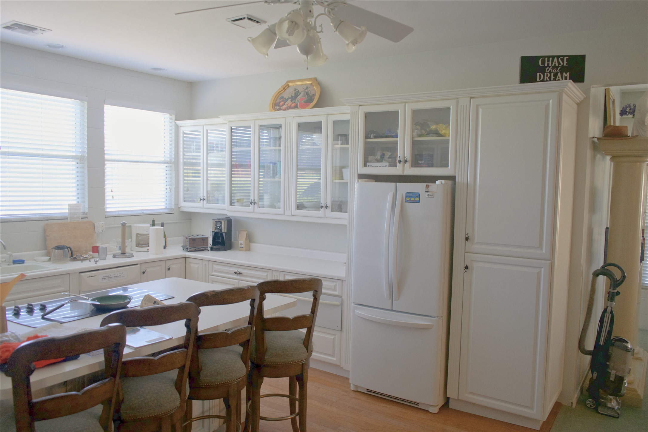 585 Hickory Spring Road Willow City, TX 78675 - Photo 17 of 25 a kitchen with a table chairs refrigerator and cabinets