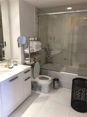 a bathroom with a sink a toilet and bathtub