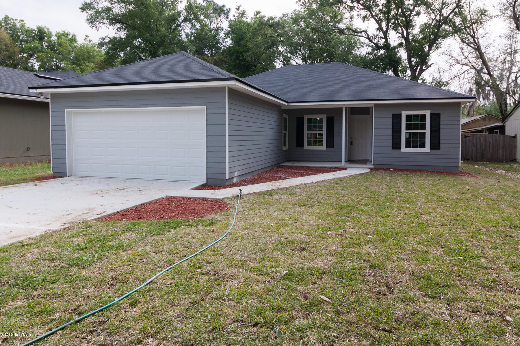 12879 Beaubien Road Jacksonville, FL 32258 - Photo 1 of 28 a front view of a house with a yard and garage