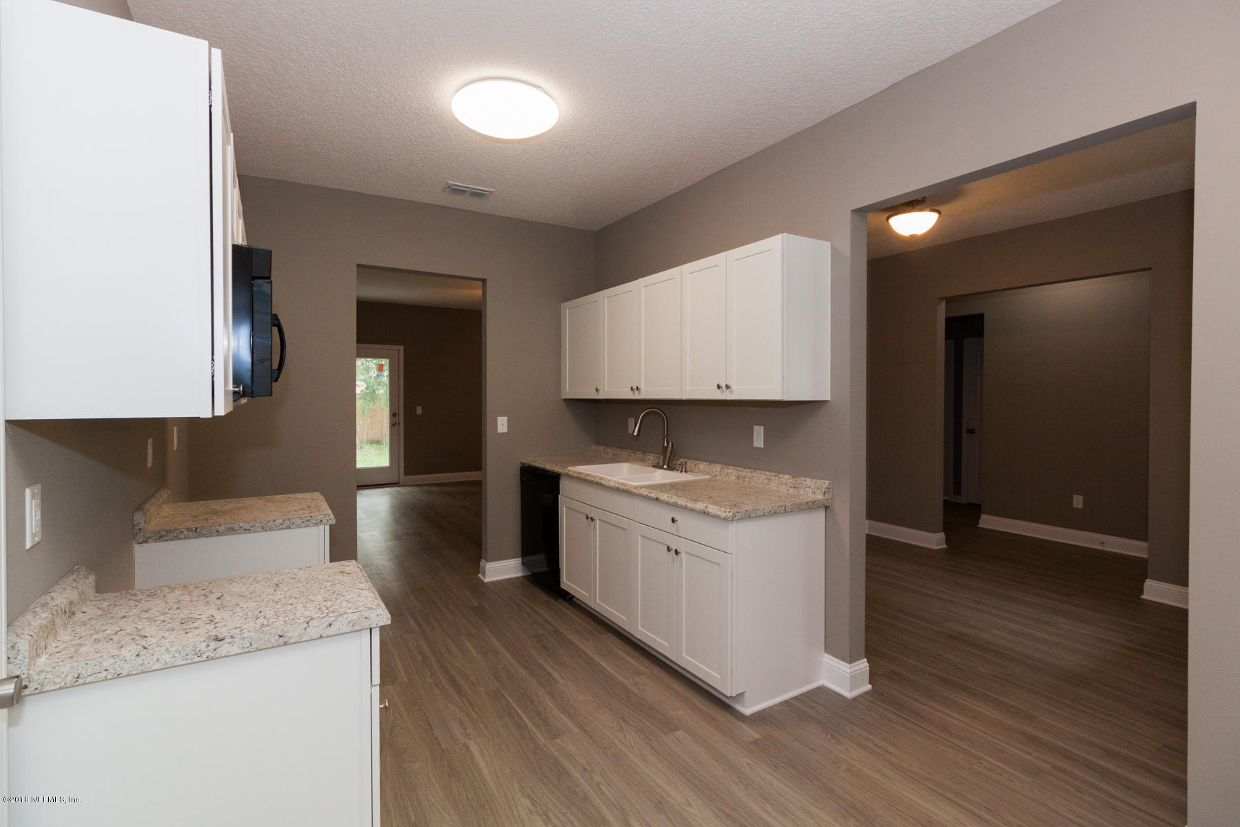 12879 Beaubien Road Jacksonville, FL 32258 - Photo 12 of 28 a large kitchen with a sink dishwasher stove and cabinets