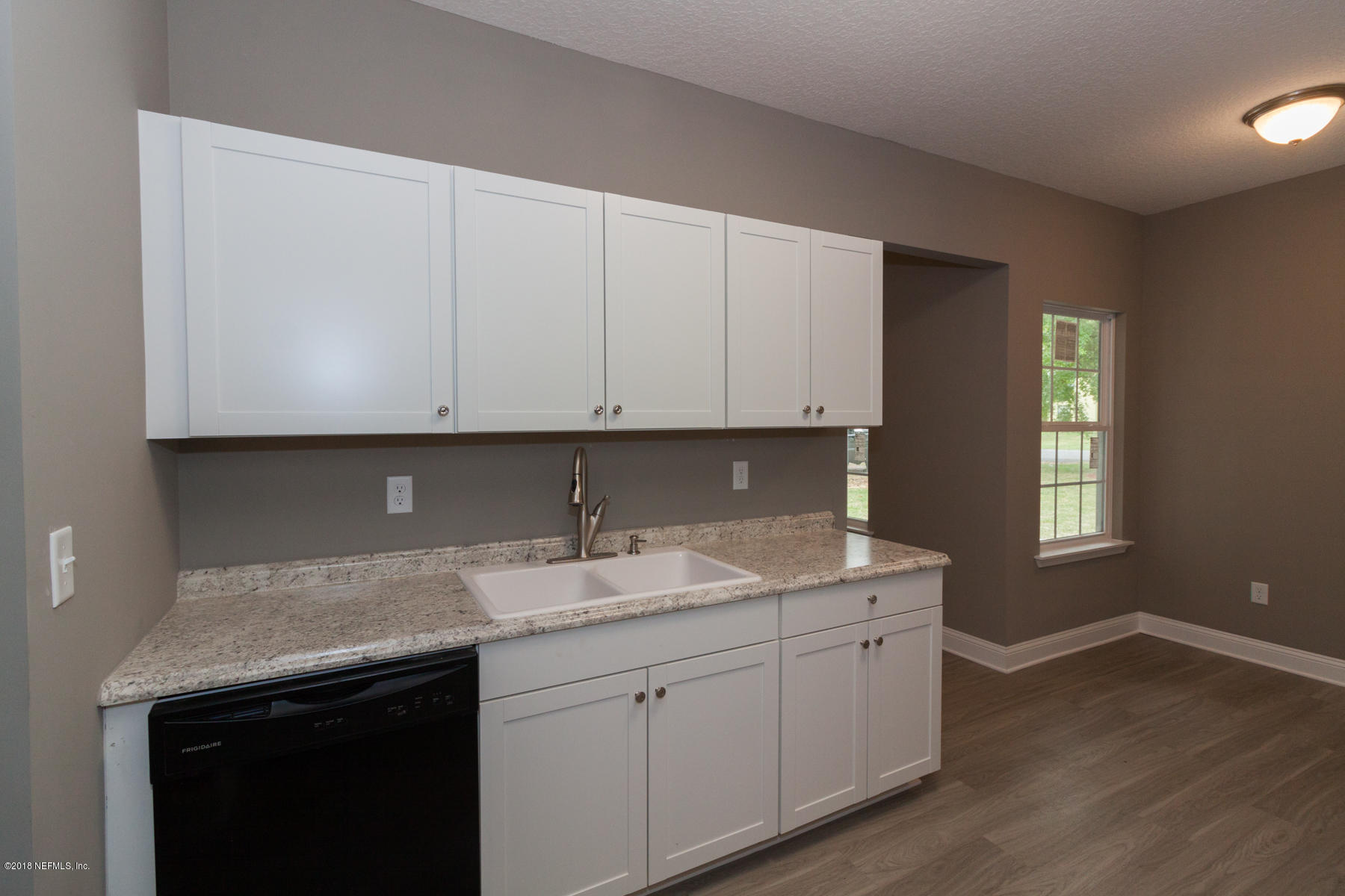 12879 Beaubien Road Jacksonville, FL 32258 - Photo 13 of 28 a kitchen with a sink cabinets and window