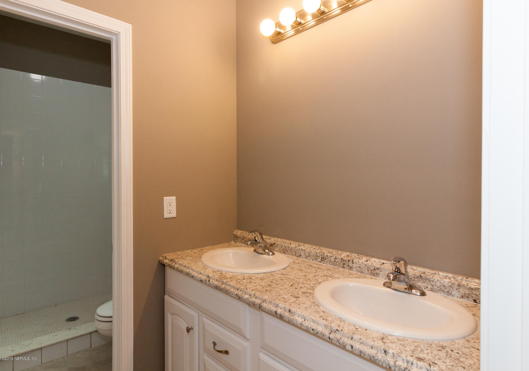 12879 Beaubien Road Jacksonville, FL 32258 - Photo 19 of 28 a bathroom with a granite countertop sink and a mirror