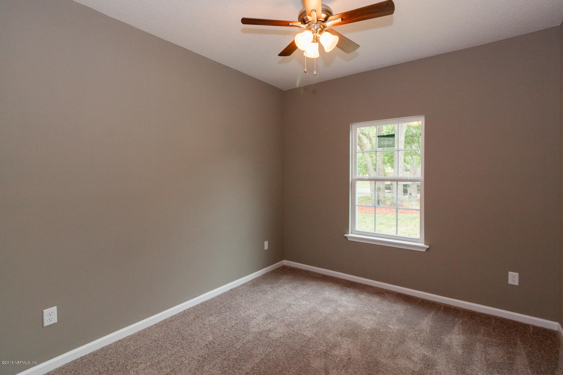 12879 Beaubien Road Jacksonville, FL 32258 - Photo 21 of 28 an empty room with a window and a fan