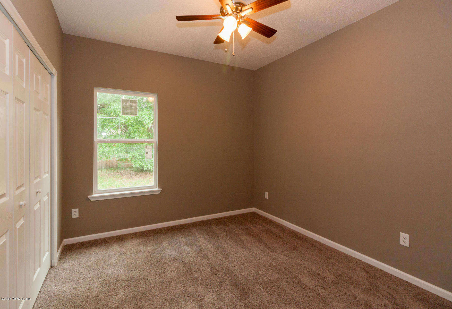 12879 Beaubien Road Jacksonville, FL 32258 - Photo 22 of 28 an empty room with a window and a fan