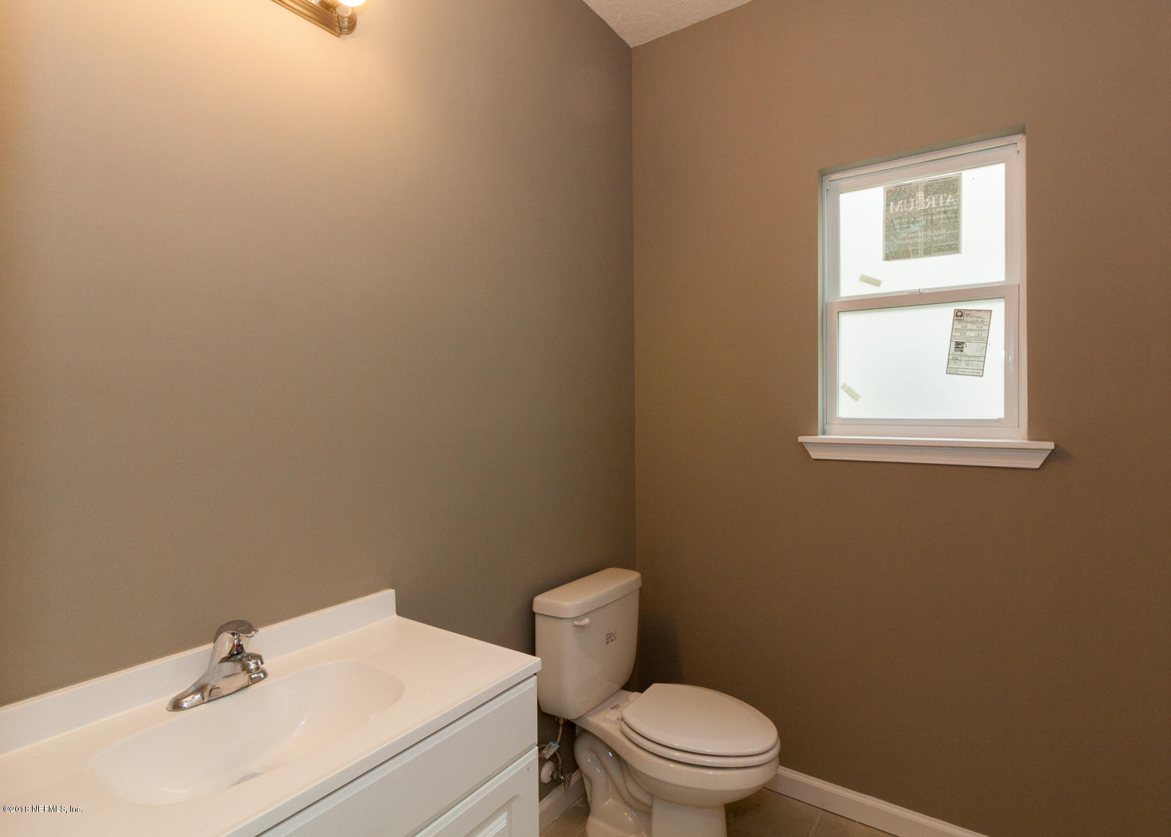 12879 Beaubien Road Jacksonville, FL 32258 - Photo 23 of 28 a bathroom with a sink a toilet and a window