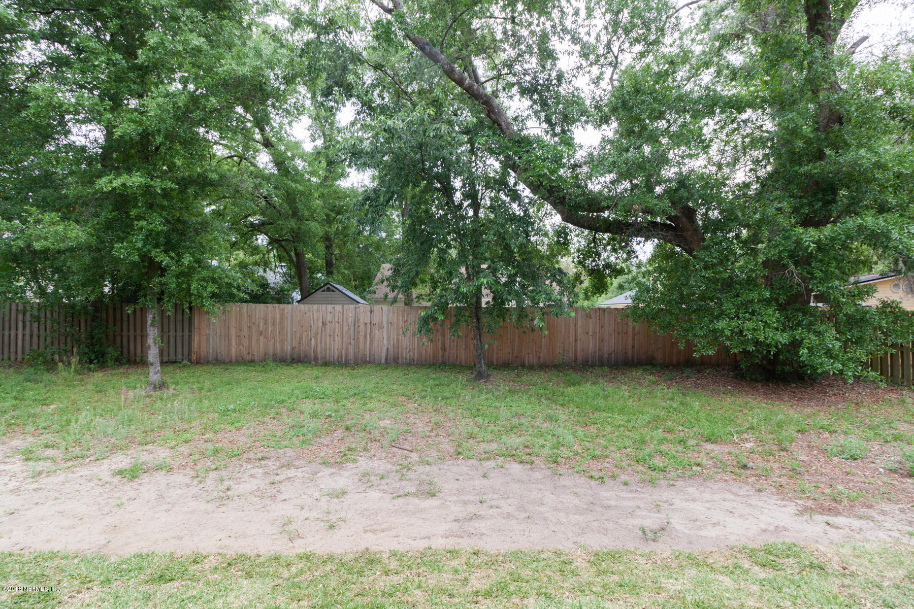 12879 Beaubien Road Jacksonville, FL 32258 - Photo 26 of 28 a view of a backyard with large trees and wooden fence