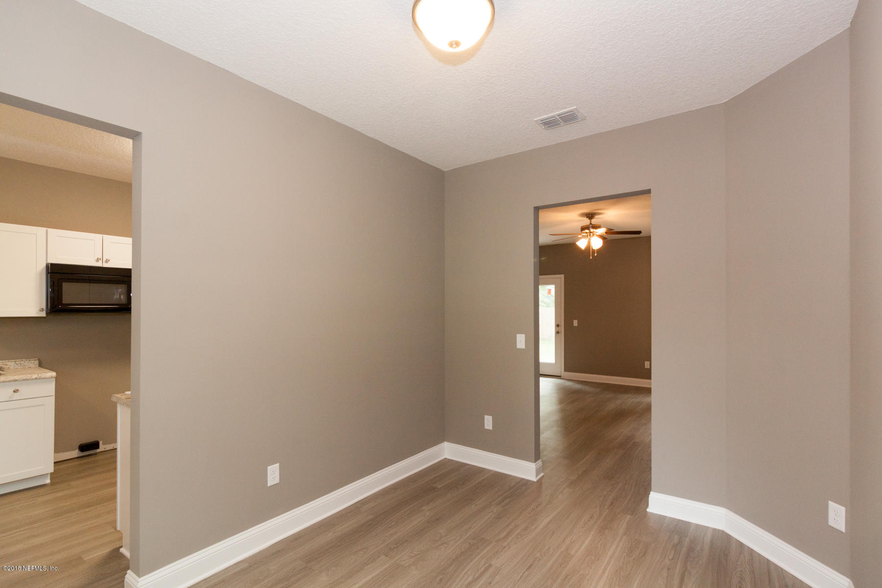 12879 Beaubien Road Jacksonville, FL 32258 - Photo 6 of 28 a view of empty room with wooden floor