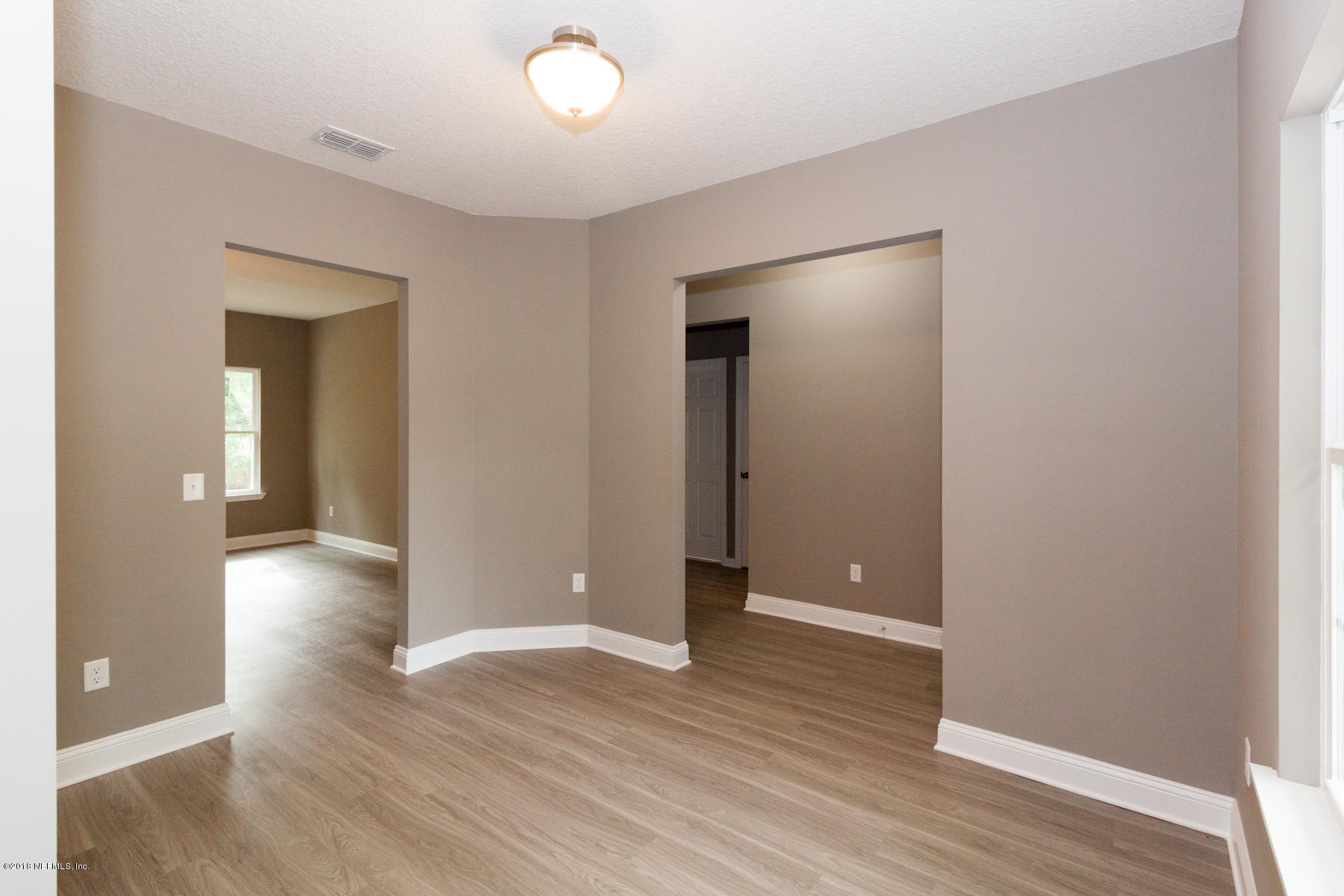 12879 Beaubien Road Jacksonville, FL 32258 - Photo 7 of 28 wooden floor in an empty room with a window