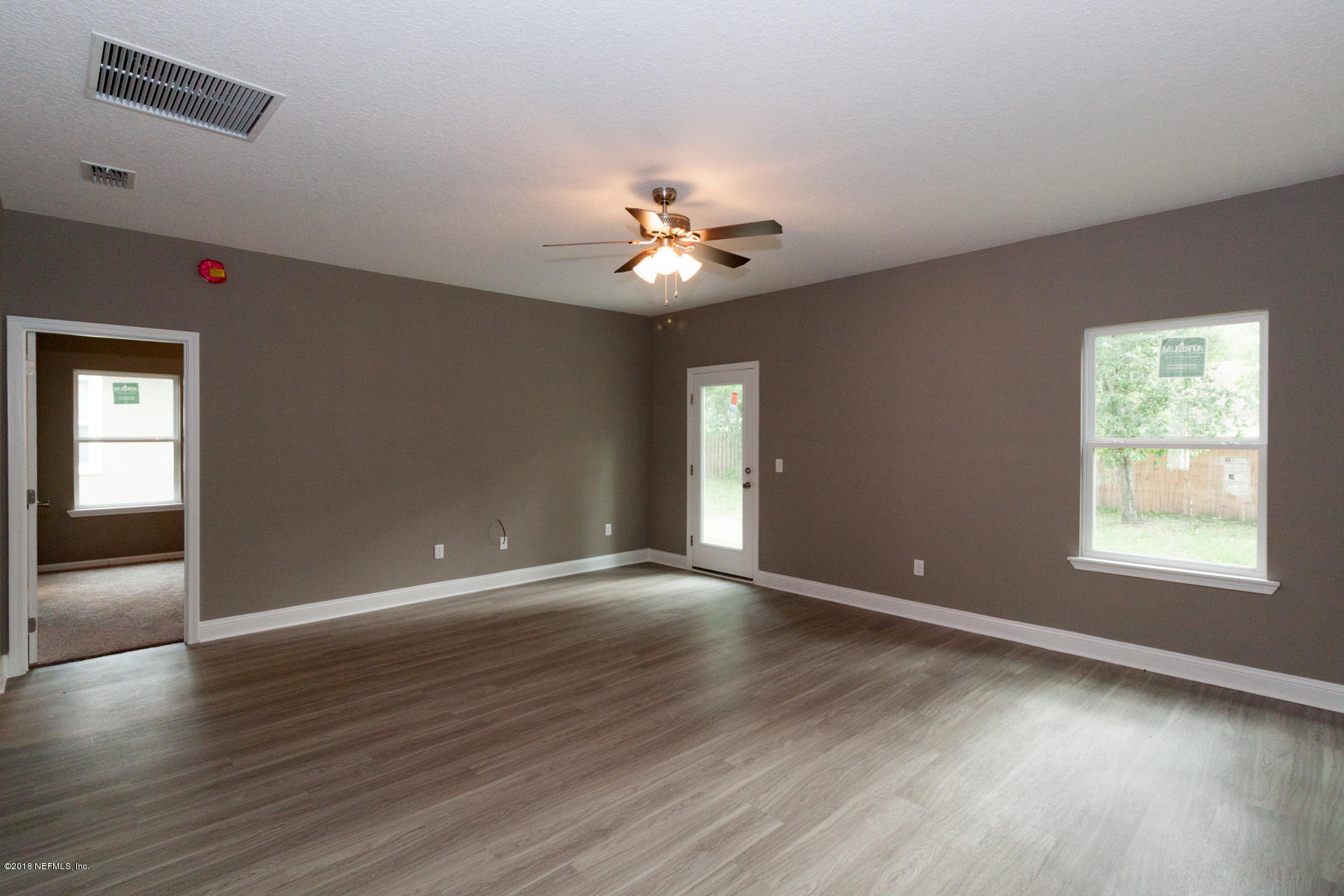 12879 Beaubien Road Jacksonville, FL 32258 - Photo 8 of 28 a view of an empty room with window and wooden floor