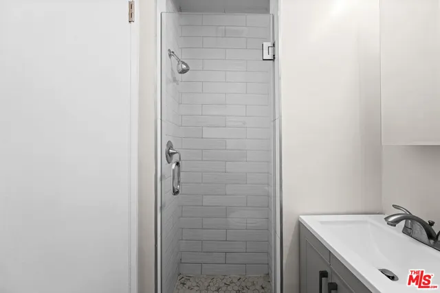 a bathroom with a sink and shower