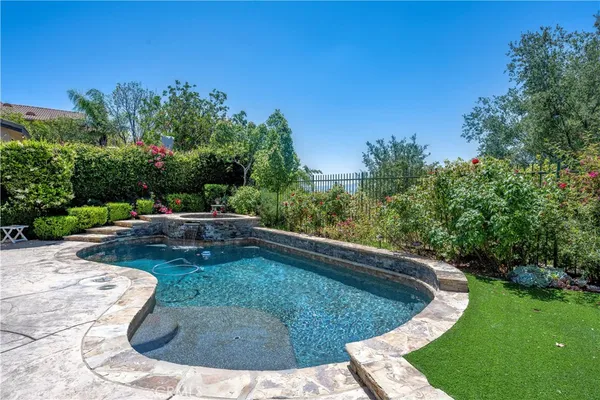 a view of a swimming pool with a yard