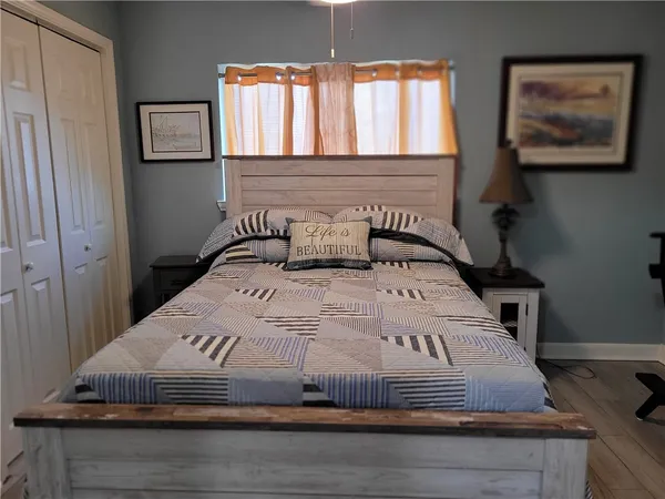 a bedroom with a bed and window