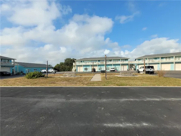 a view of big yard with a large trees