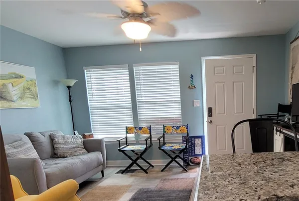 a living room with furniture windows and a flat screen tv