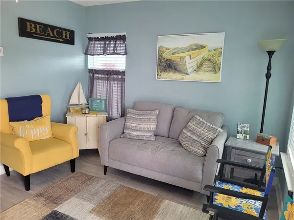 a living room with furniture and a painting on the wall