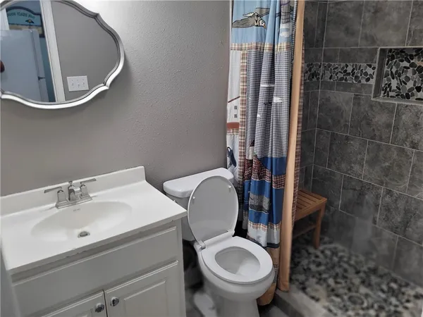 a bathroom with a sink toilet and shower