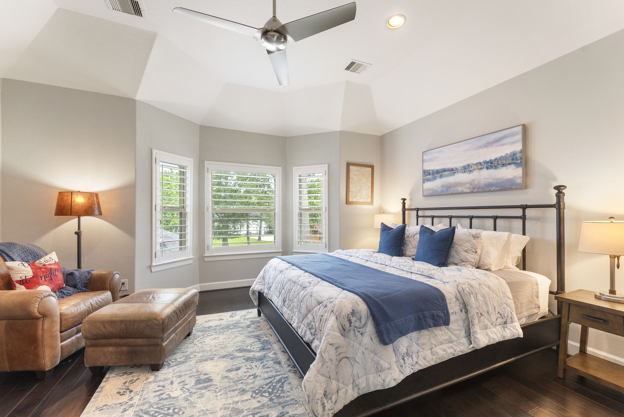25607 Muirfield Bend Court Spring, TX 77389 - Photo 21 of 30 Inviting upstairs bedroom highlighted by vaulted ceilings, oversized windows, and beautiful views of the private backyard oasis, creating a comfortable retreat for family and guests.